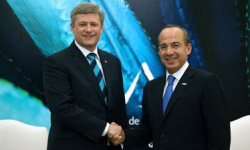 Mexican President Felipe Calderon and Canadian Prime Minister Stephen Harper shake hands during a summit of the Security and Prosperity Partnership of North America. (Photo by Alfredo Guerrero)